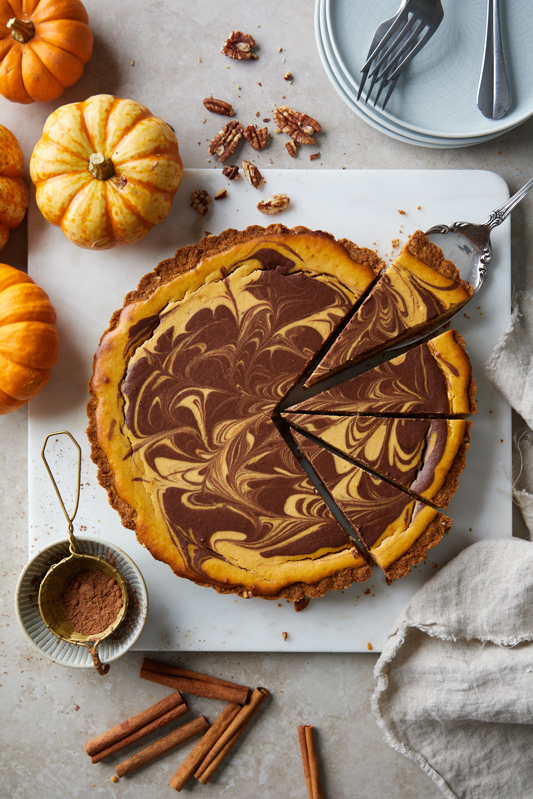 Marbled Chocolate Cheesecake Pumpkin Tart With A Biscoff Pecan Crust