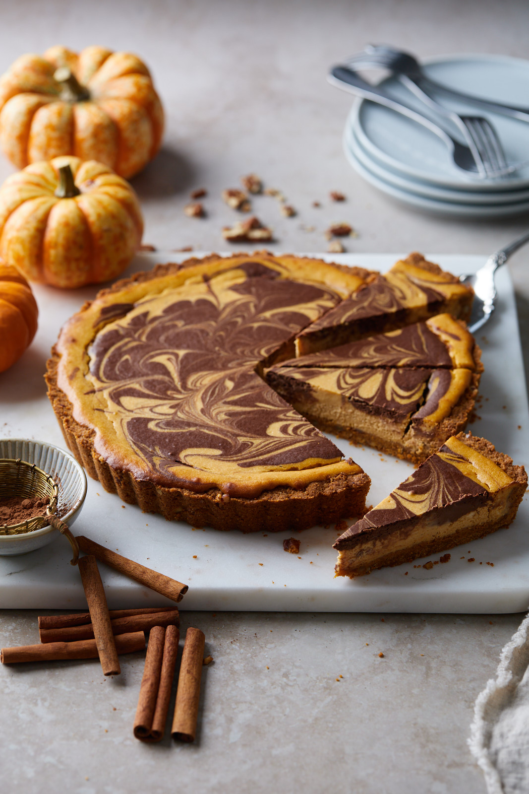 Marbled Chocolate Cheesecake Pumpkin Tart With A Biscoff Pecan Crust