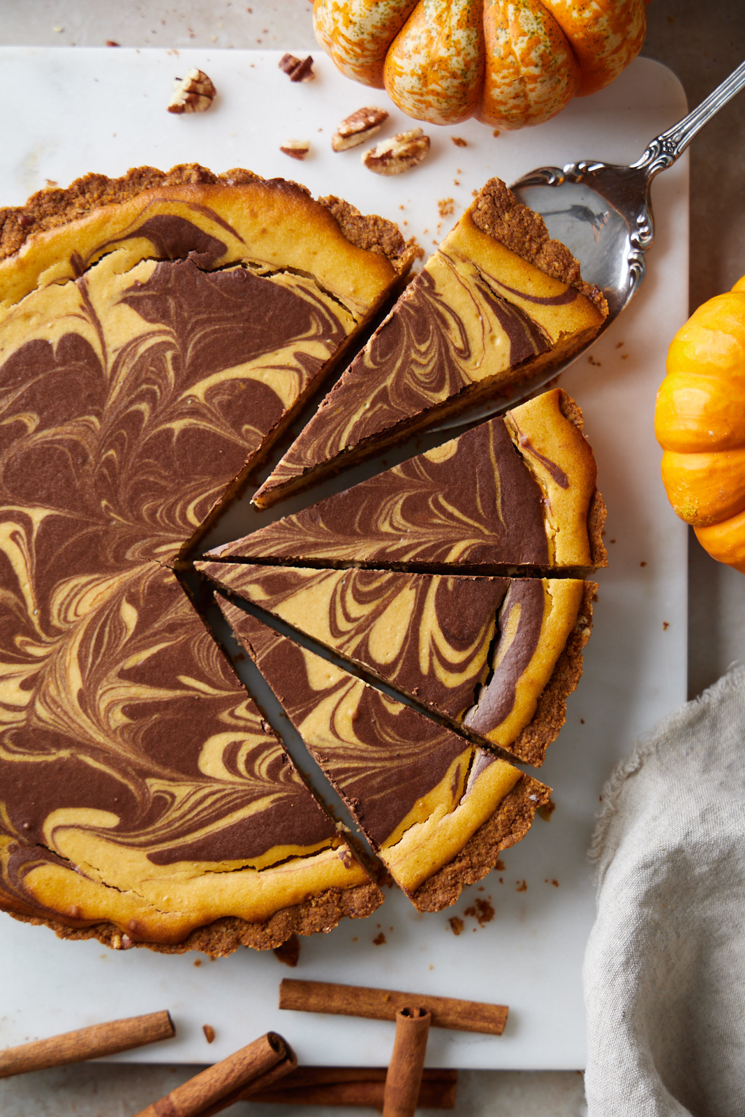 Marbled Chocolate Cheesecake Pumpkin Tart With A Biscoff Pecan Crust