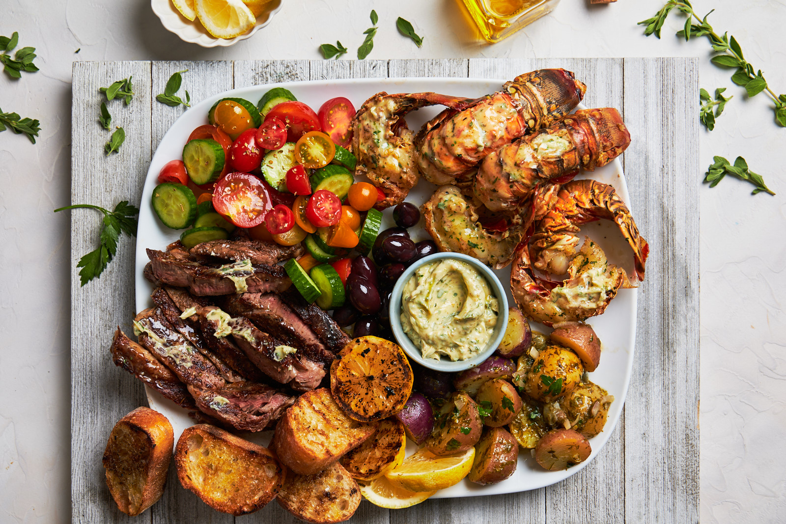 Grilled Lobster Tail And Steak Platter With A Greek Chimichurri Butter Olive Mango