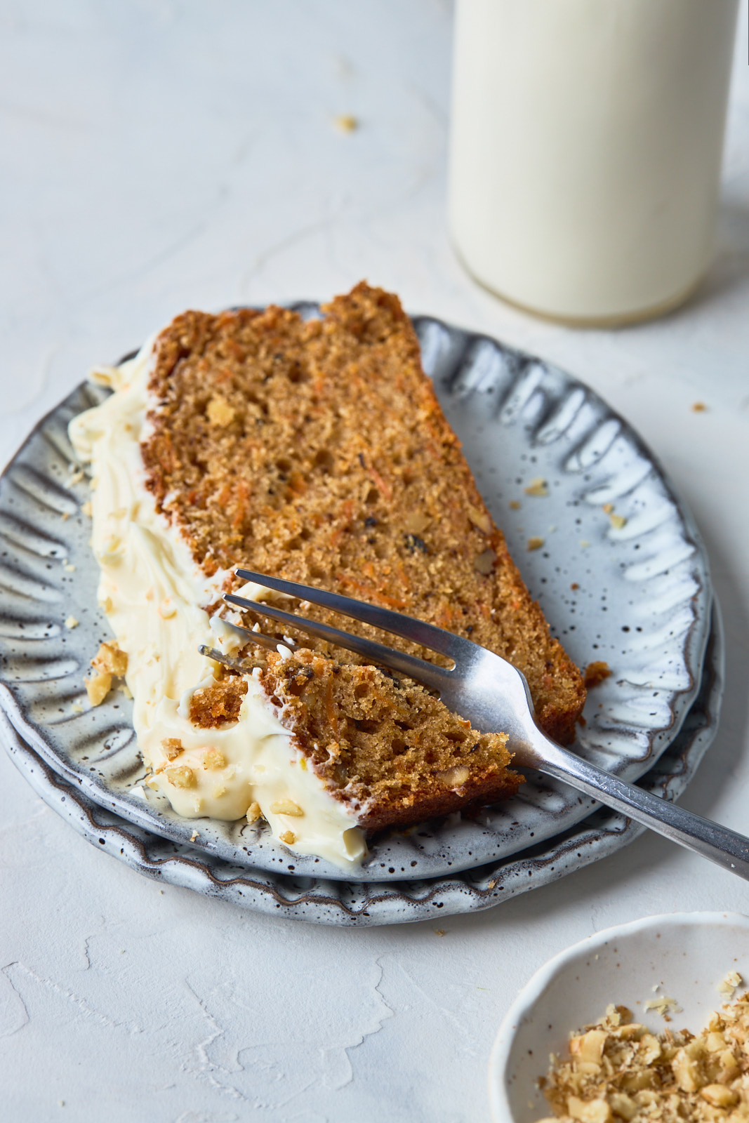 Carrot Cake Loaf slice on a plate with a fork in it