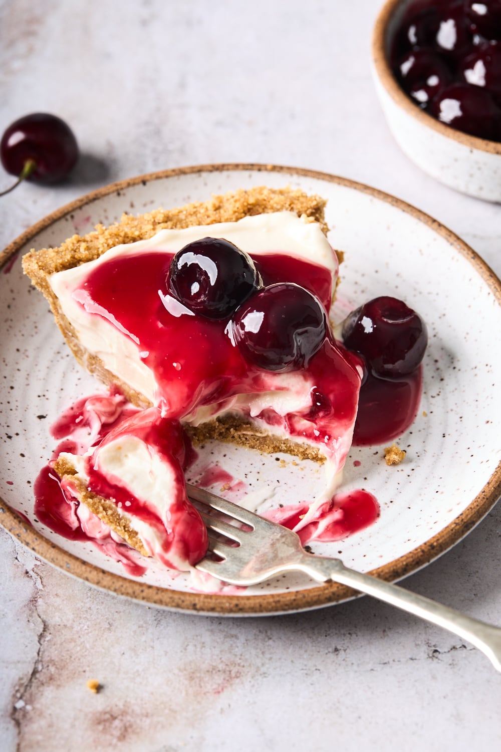 A slice of Philadelphia No Bake Cheesecake with cherries