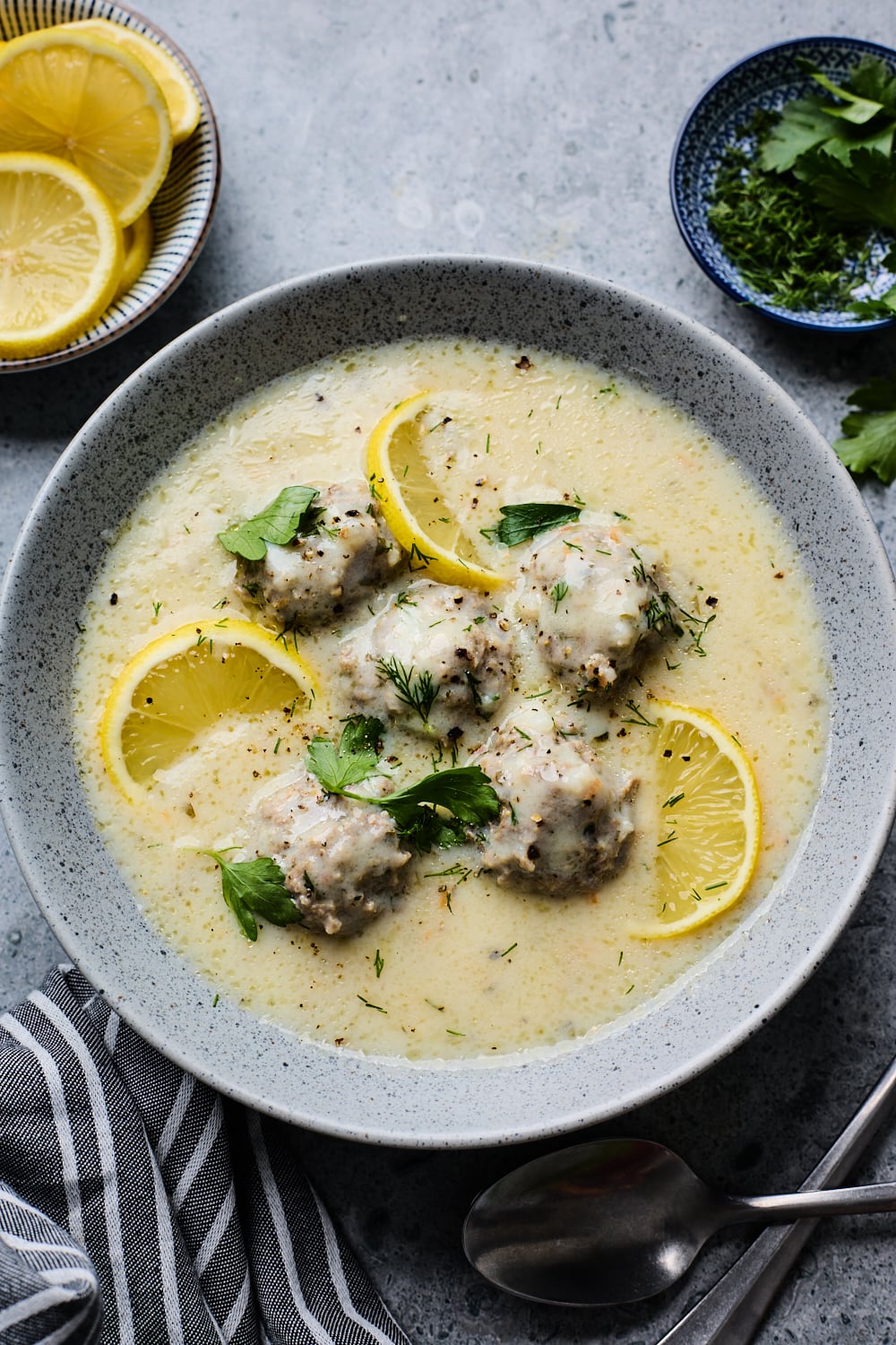 A bowl of Youvarlakia Avgolemono soup with meatballs